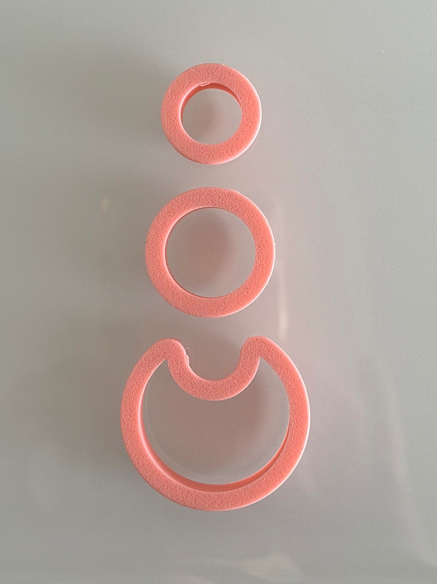 Three-piece modern layered circle polymer clay cutter set for creating geometric statement earrings.