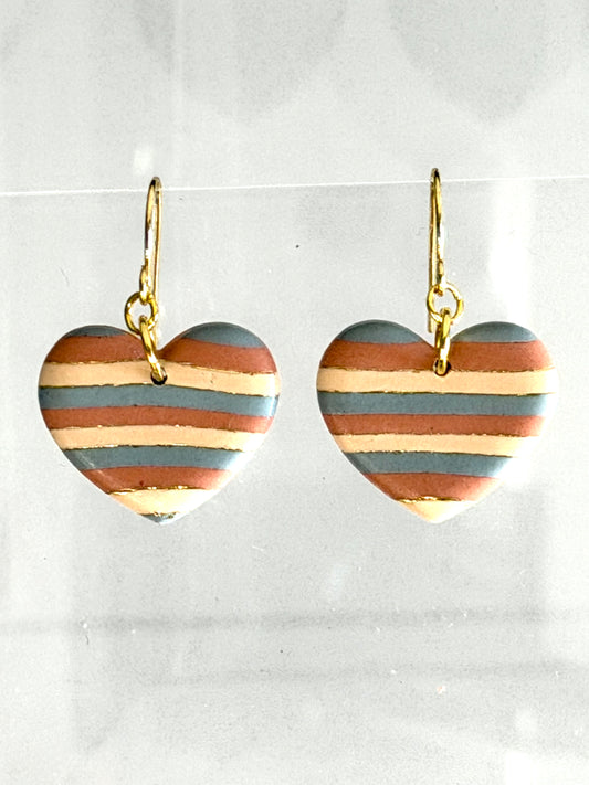 Painted Desert heart dangle earrings with soft striped polymer clay in turquoise, terracotta, and sand tones with gold accents on gold hooks