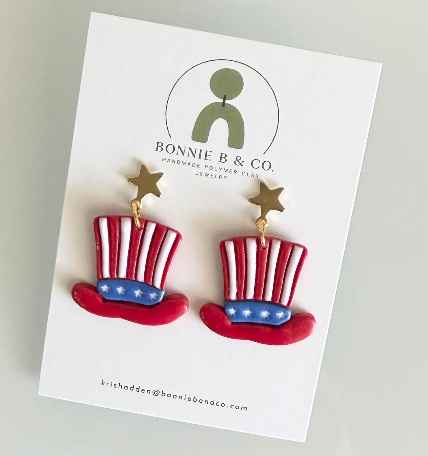 Handmade polymer clay Uncle Sam Hat earrings with red white and blue patriotic design and gold star stud toppers.